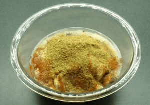 Chicken covered with spices in a bowl