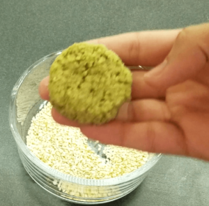 shaping raw falafel mixture into patties before frying
