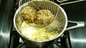 frying Egyptian falafel in hot oil until golden and crispy