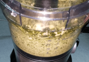 blending fava beans with herbs for homemade Egyptian falafel