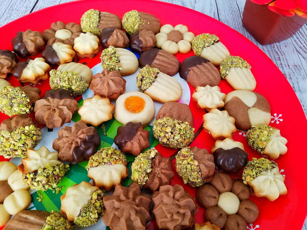Egyptian Betefour Cookies decorated with chocolate, pistachios, and jam in a big platter.