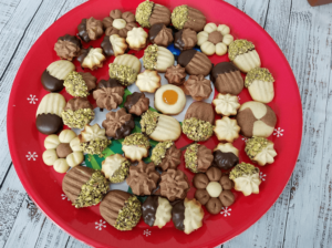 Egyptian betefour cookies on tray with chocolate dipped butter cookies, pistachios, and jam filling