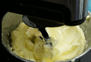 mixing egg yolks and vanilla into butter mixture for betefour cookies dough