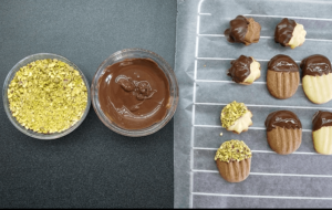 decorating betefour cookies with chocolate, pistachios, and jam filling