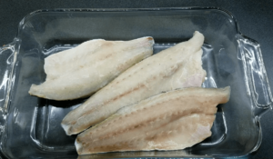 Mediterranean sea bass fillet arranged in baking dish