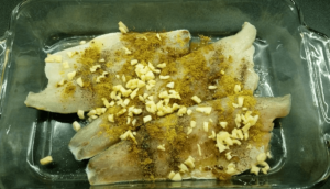 Sea bass fillet seasoned with garlic, and Mediterranean spices.