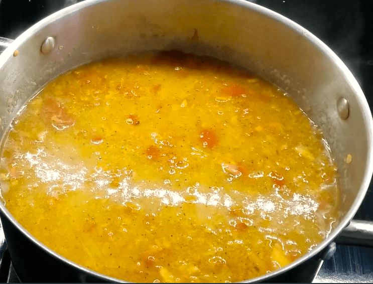 Mixing lentils and broth.