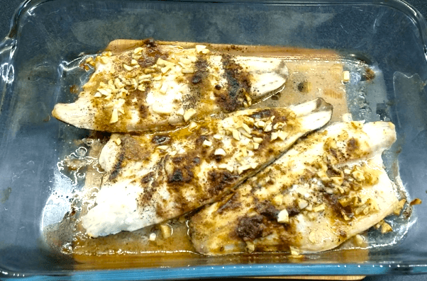 Mediterranean sea bass baking in the oven until tender and flaky