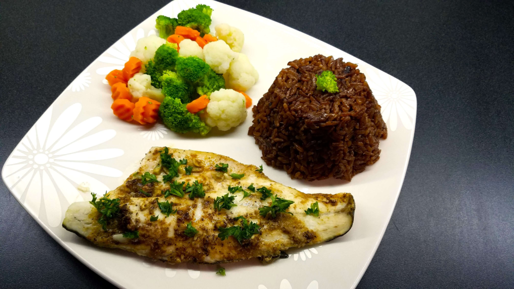 Baked Mediterranean sea bass fillets served with fresh lemon and parsley