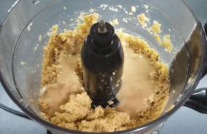 Adding tahini to hummus for a creamy texture