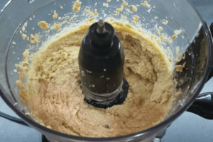 Adding cold water to hummus for a smooth and creamy texture