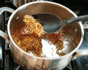 Toasting vermicelli in oil for Egyptian koshari rice until golden brown