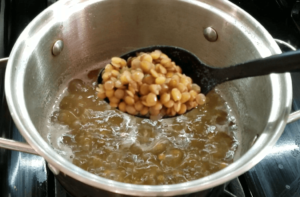 Cooking lentils for easy homemade Egyptian koshari recipe until tender but not mushy