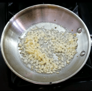 Cooking garlic for Egyptian koshari tomato sauce