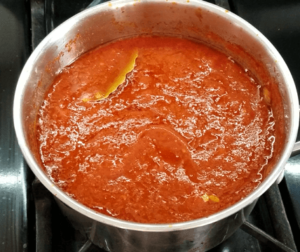 Simmering tomato sauce for Egyptian koshari