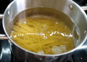 Boiling pasta for easy shrimp scampi pasta recipe until al dente
