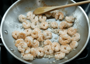 Shrimp cooking in garlic butter sauce for shrimp scampi pasta
