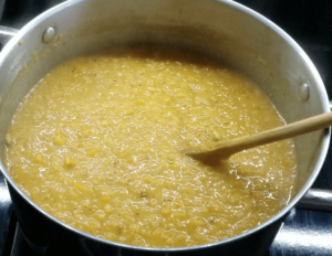 Stirring the creamy Egyptian red lentil soup
