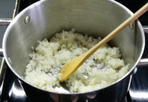 Cooking onions for the Egyptian red lentil soup