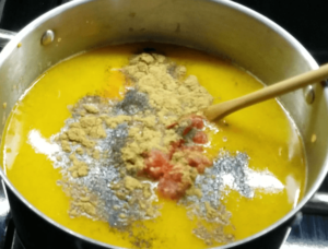 Added water, tomatoes, and spices to the Egyptian red lentil soup