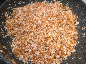 rice with vermicelli coated with oil in a pan