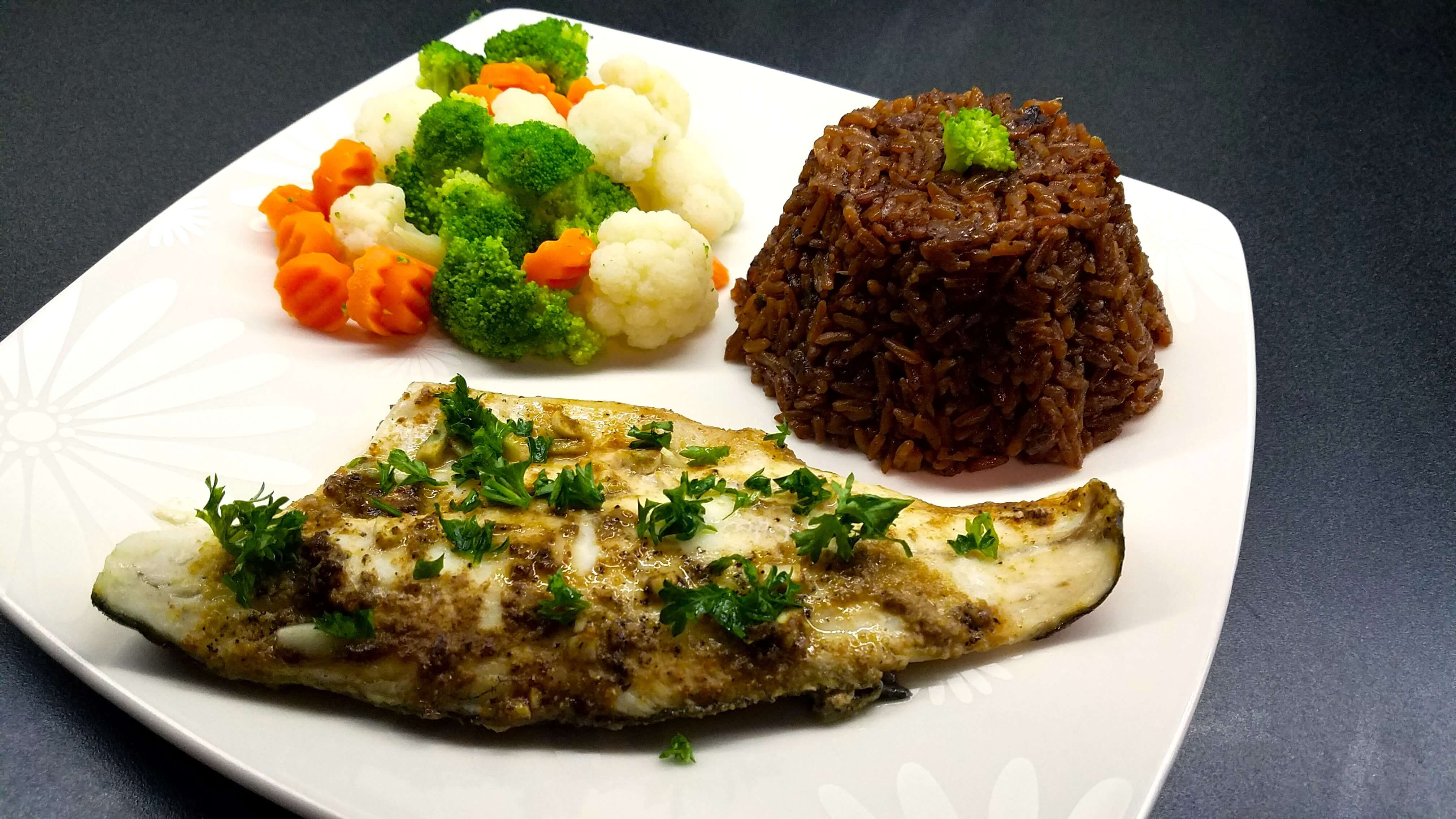 Baked sea bass finished with fresh lemon juice and chopped parsley