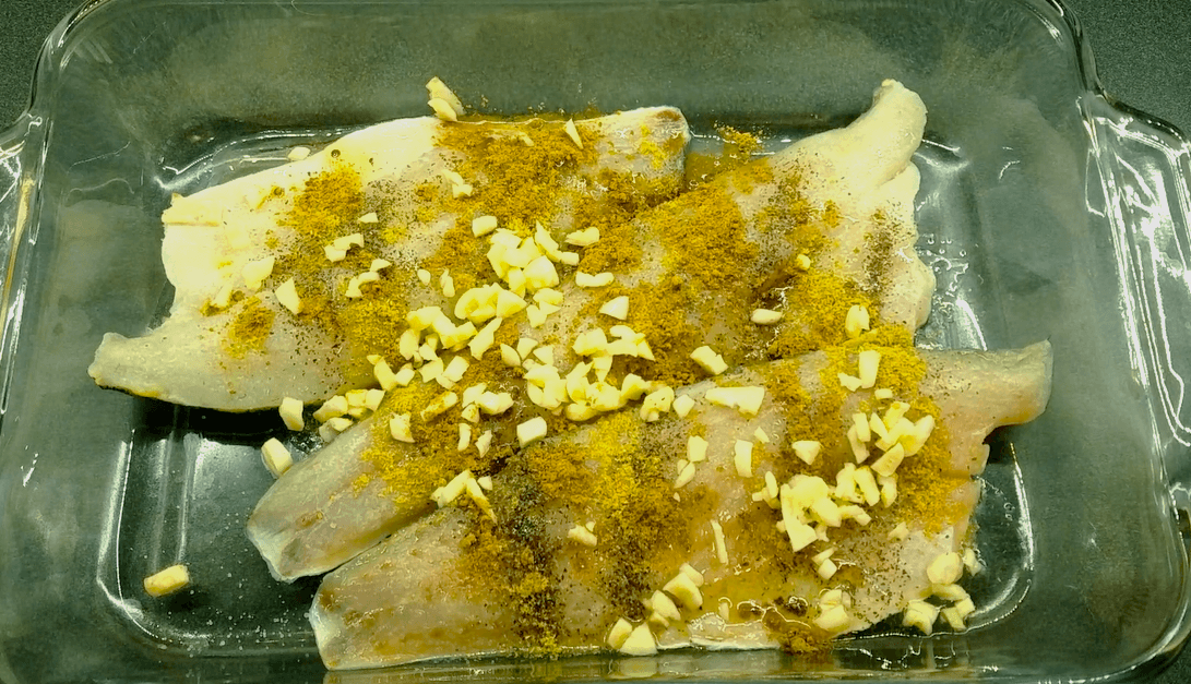 Sea bass fillets seasoned with fresh garlic, cumin, coriander, oregano, salt, and pepper