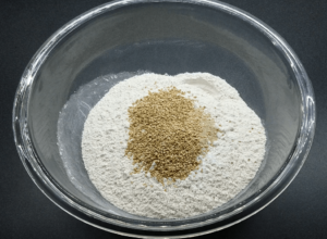bowl with flour, yeast and sesame seeds