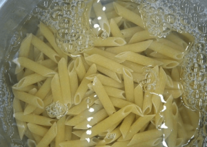 Penne pasta in a pot of water