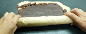 rolling the dough into a log