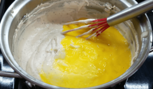 Adding eggs to the bechamel sauce