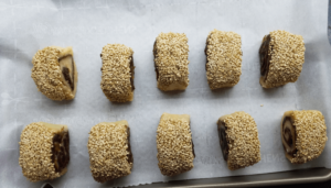 Cookies are placed on a lined baking pan