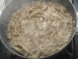 Browned beef liver strips in a skillet