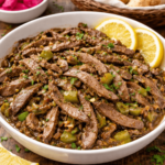 Kebda Eskandarani in a bowl with lemon wedges