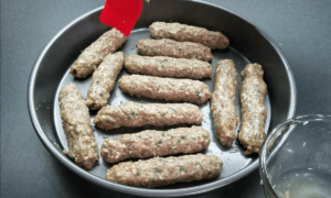 brushing kofta kebabs with onion juice