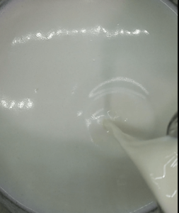 Adding heavy cream to the rice pudding