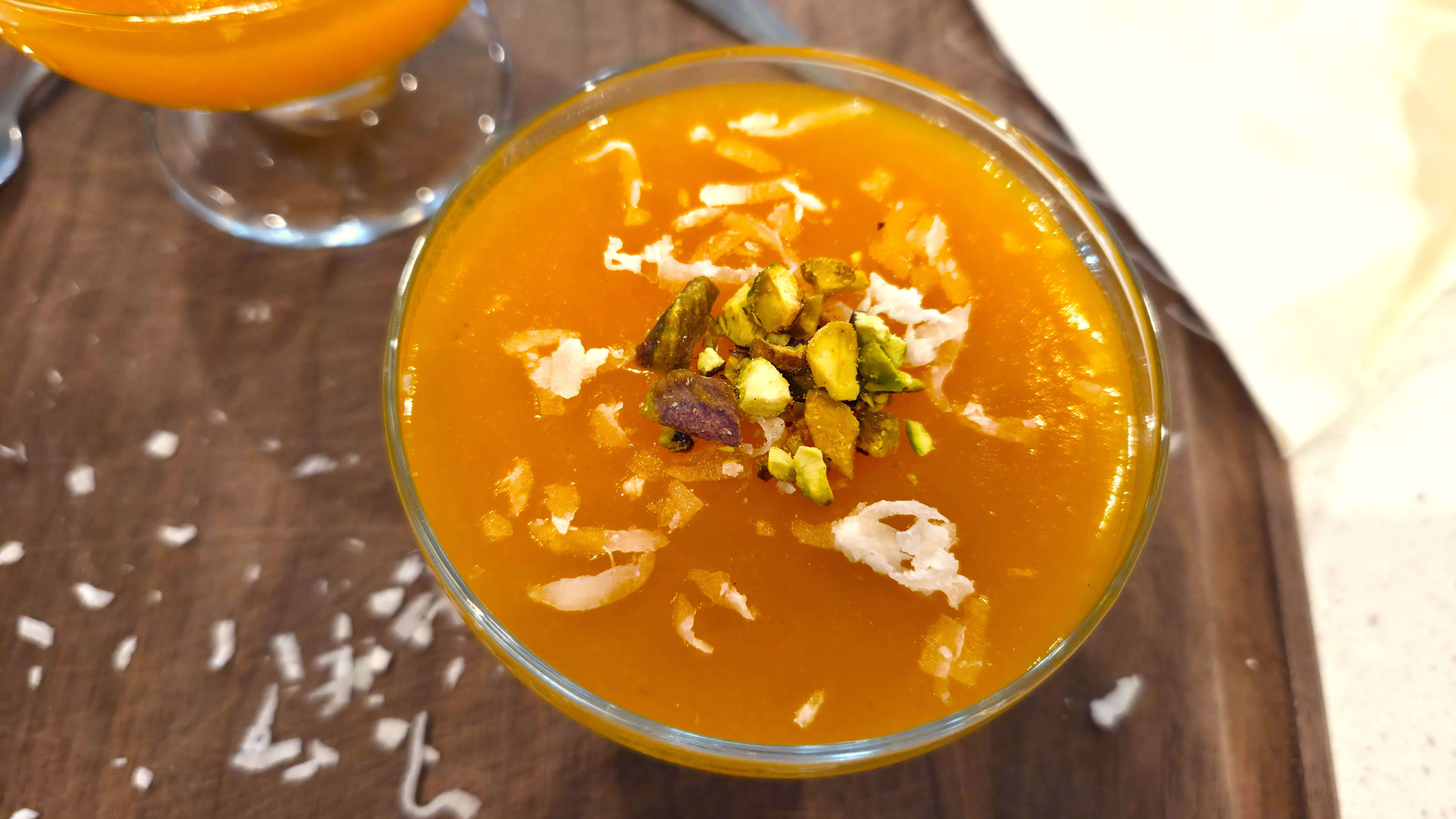 A beautiful close-up of a single chilled bowl of orange apricot pudding.