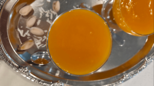 Pouring qamar al din pudding into serving bowls before chilling