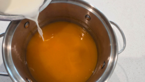 Stirring apricot pudding with cornstarch to achieve smooth texture