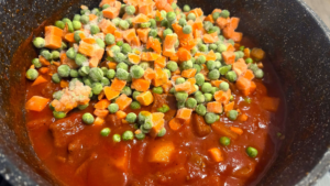 Peas and carrots added to Egyptian beef stew