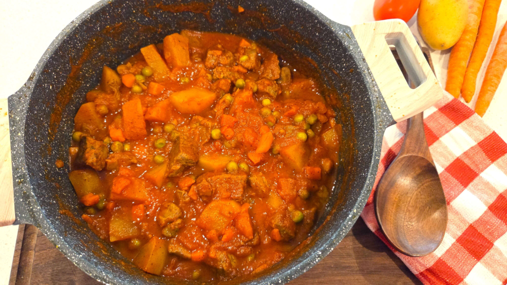 Authentic Egyptian beef stew with peas and carrots served in tomato sauce