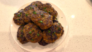 Cooked Turkish beef kofte garnished with fresh parsley
