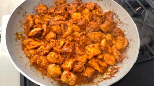 Cooking Mediterranean spicy honey garlic chicken bites in a skillet until golden brown