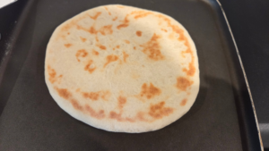 Cooking Turkish flatbread in a hot skillet until golden