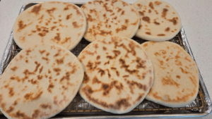 Cooked Turkish flatbread on a cooling rack