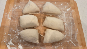 Dividing Turkish flatbread dough into equal dough