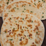 Soft and fluffy Turkish flatbread recipe served warm with olive oil parsley and red pepper flakes