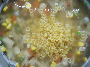Adding small pasta shells to Egyptian chicken noodle soup