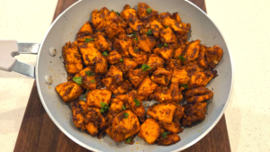 Mediterranean spicy honey garlic chicken bites garnished with fresh chopped parsley