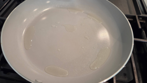 Heating a skillet on the stovetop for cooking Turkish beef kofte